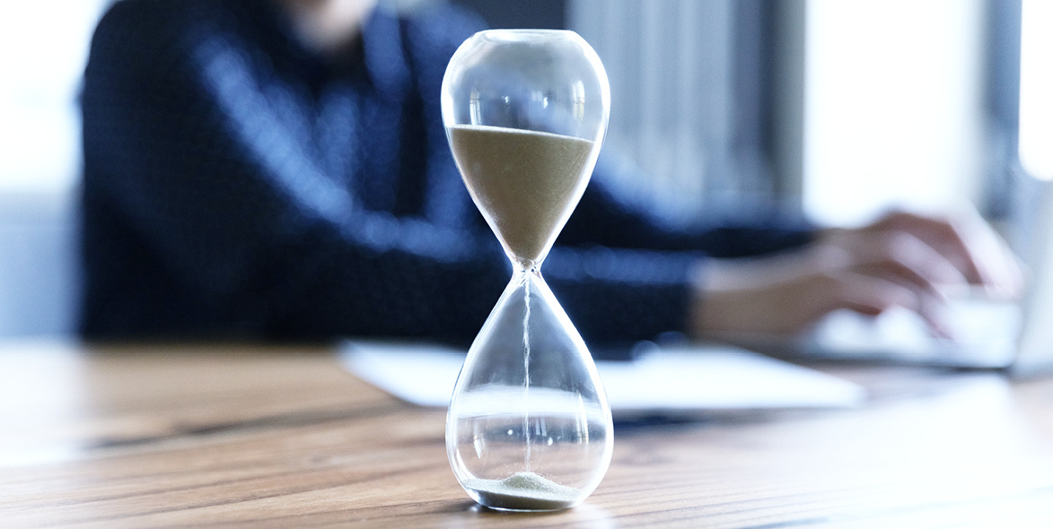 An hourglass with most of the sand in the upper section